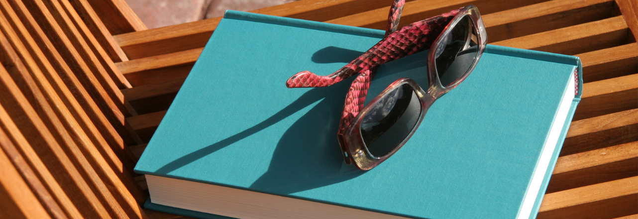photo of a pair of sun sunglasses on a book