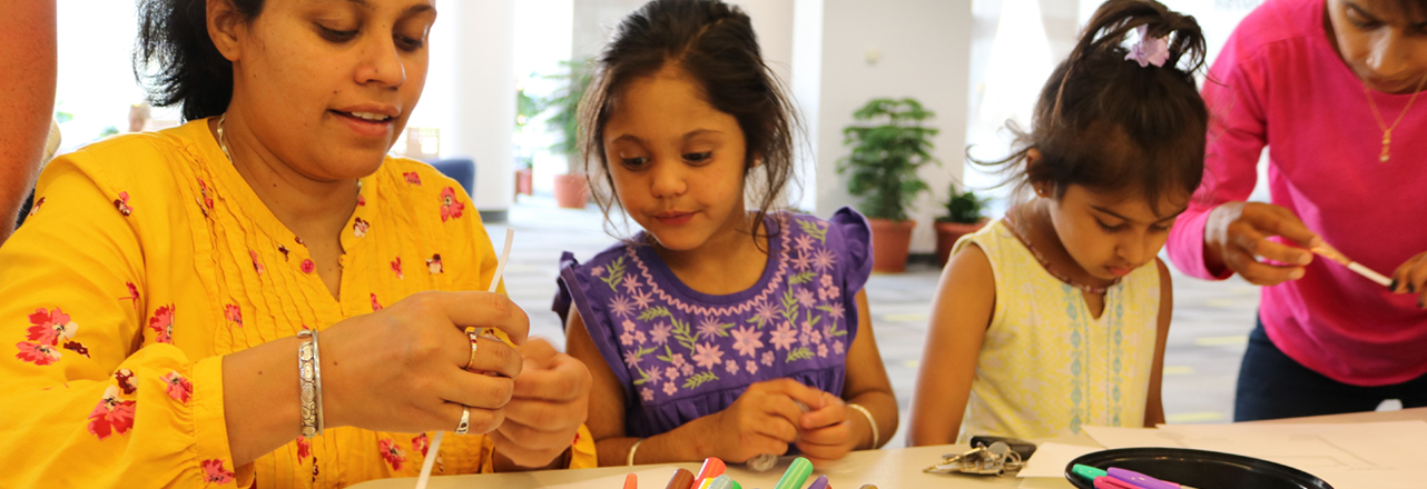 girls making crafts with mom