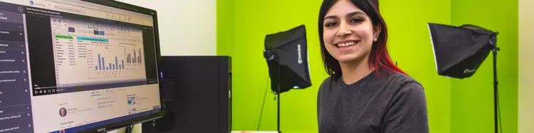 photo of a smiling woman at a computer