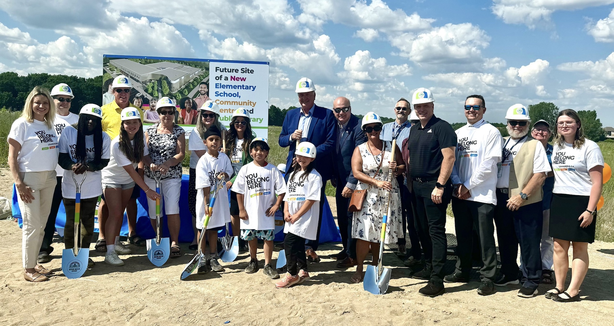 group of people with shovels at groundbreaking